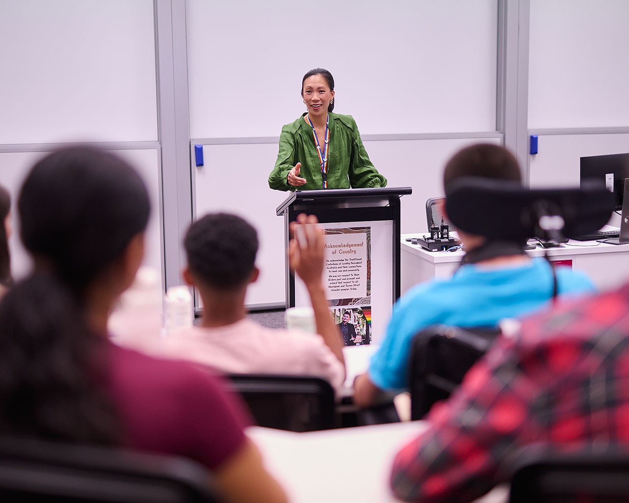 Lecturer in lecture theatre taking questions